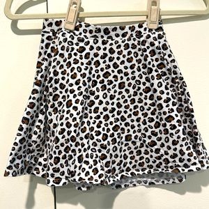 Girls leopard print skirt with built in shorts. Size 8.